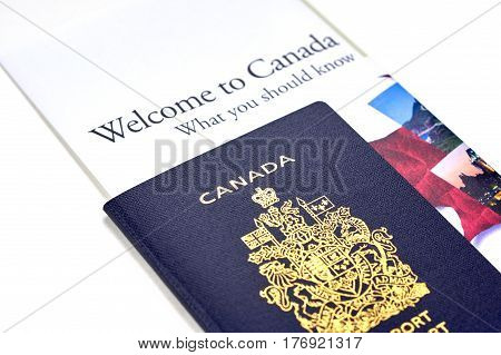 MONTREAL CANADA - MARCH 10 2017 : Canadian passport with 'Welcome to Canada' informational brochure from Citizenship and Immigration Canada Ministry