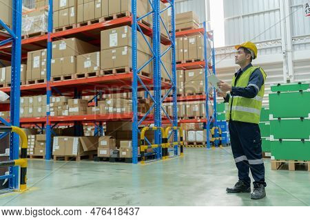 Asian Male Factory Manager Inspect Goods In Warehouse Or Inventory And Check Stock Product. Transpor