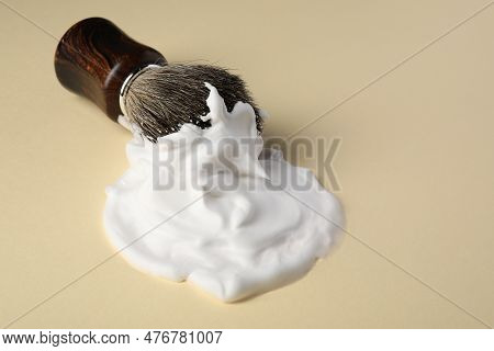 Brush With Shaving Foam On Beige Background, Closeup