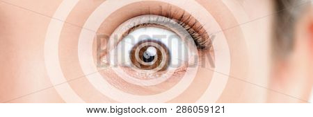 Hypnosis therapy for ocd mental help problems. Closeup of eye with graphic spiral design over eyes of woman hypnotized banner panorama. Asian girl hypnose portrait background.