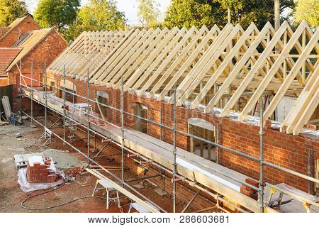 Uk Building Site With Scaffolding. Part Of A Period House Is Restored Using Modern Building Methods.