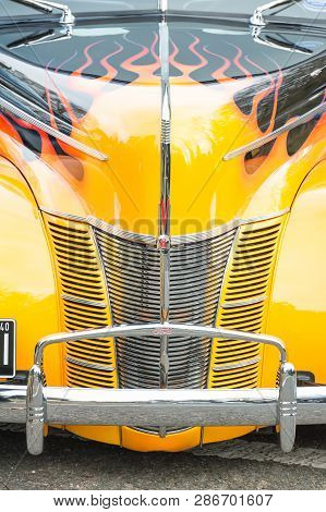 Hook, Uk - January 1: Close-up Of A Chromed Grille And Vivid Sunset Yellow And Flame Paintwork On A 