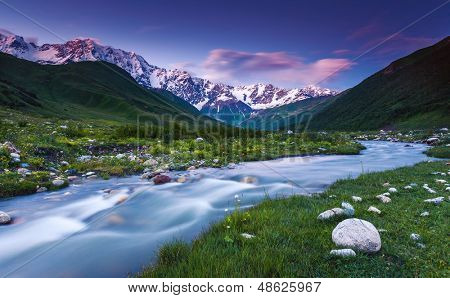 River in mountain valley at the foot of  Mt. Shkhara. Upper Svaneti, Georgia, Europe. Caucasus mountains. Beauty world.