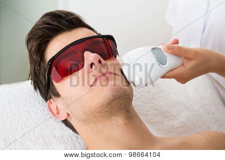 Man Receiving Laser Hair Removal Treatment