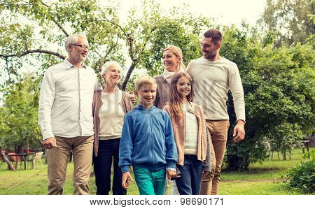 family, happiness, generation, home and people concept - happy family standing in front of house outdoors