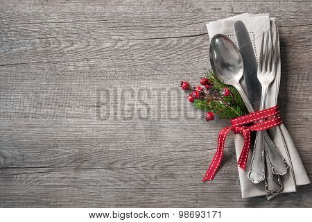 Christmas table place setting with christmas pine branches,ribbon and bow. Christmas holidays background