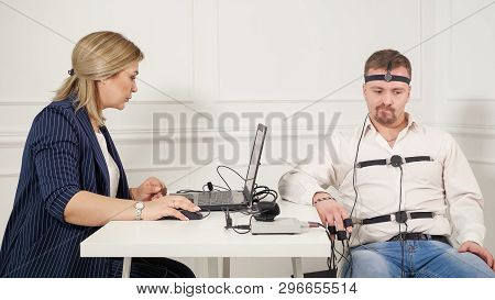 Young Handsome Suspect During Interrogation Undergoes Lie Detector Connected To The Machine He Answe