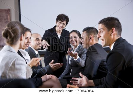 Diverse Businesspeople Conversing, Woman At Front