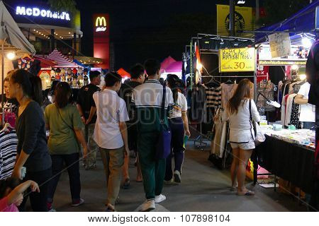 People Walking And Shopping At The Night Market