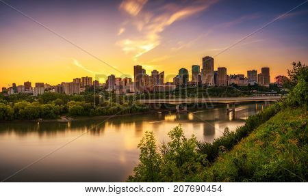 Sunset above Edmonton downtown, James Macdonald Bridge and the Saskatchewan River, Alberta, Canada. Long exposure.