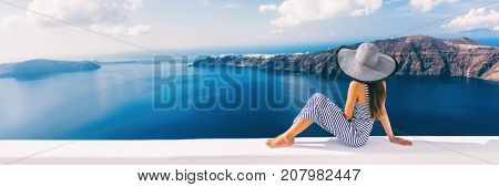 Travel luxury cruise vacation holiday woman panoramic banner. Sun hat maxi dress woman relaxing at sea view in Santorini, Oia, Greece. Europe destination.