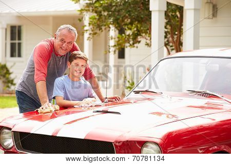 Grandfather And Grandson Cleaning Restored Classic Car