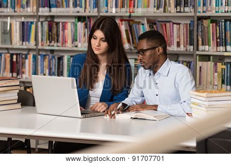 Young Students Using Their Laptop In A Library