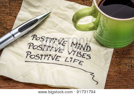 positive mind,  positive vibes, positive life - motivational handwriting on a napkin with a cup of coffee