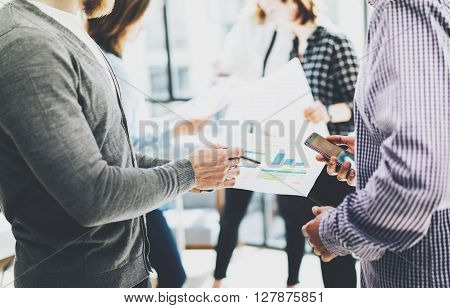 Business meeting office.Closeup photo documents holding hands. Photo account managers crew working with new startup project.Idea presentation, analyze marketing plans.Blurred, film effect.