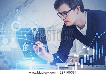 Young Market Analyst In Casual Clothes And Glasses Working With Digital Business Interface In Blurry