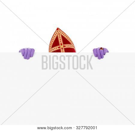 Sinterklaas or saint Nicholas hiding behind blank cardboard. isolated on white background. Dutch character of Santa Claus