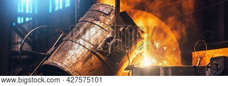 Heavy Metallurgy Horizontal Banner Background. Iron Cast Process. Liquid Molten Metal Pouring Into M