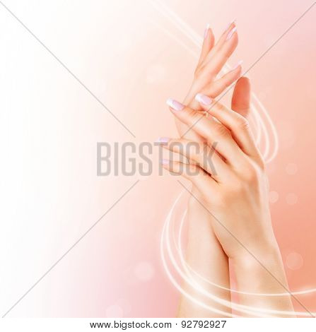 Beautiful Healthy Female Hands. Spa and Manicure concept. Woman hands with french manicure. Soft skin, skincare concept. Beauty nails. over beige background