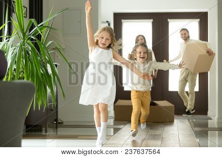 Excited Funny Kids Boy And Girl Running Inside Luxury Big Modern House On Moving Day, Cute Children 