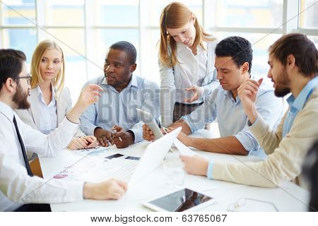 Group of confident business partners interacting at meeting