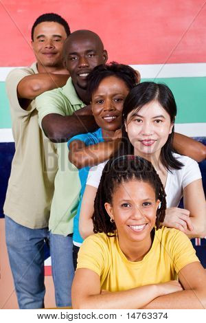 group of young diversity people in front of South African flag, 2010 concept