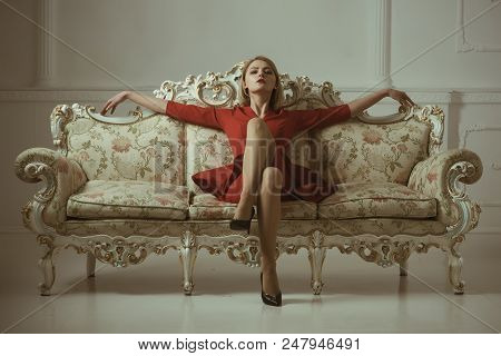 Realtor Company. Woman Realtor In New Apartment. Come Home With Confidence. Woman On Sofa Presenting