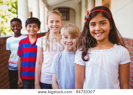 Portrait of smiling little school kids in school corridor