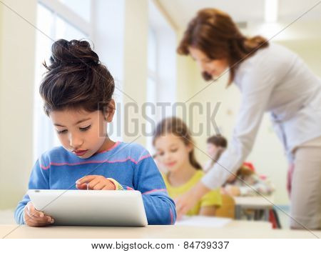 education, elementary school, technology and children concept - little student girl with tablet pc over classroom and teacher background