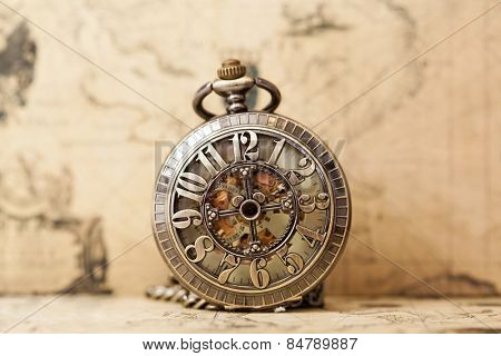 Vintage clock on antique map. Retro still life