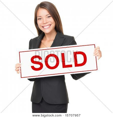 Real estate agent holding sold sign isolated on white background. Beautiful cheerful Asian / Caucasian female realtor smiling confident in black suit.