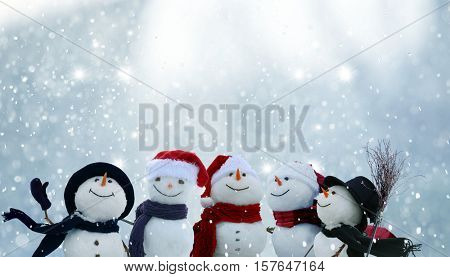 Merry Christmas and happy New Year greeting card with copy-space.Many snowmen standing in winter Christmas landscape.Winter background