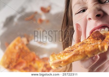 young kid eating fast food pizza