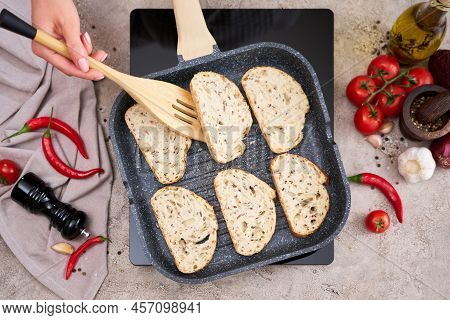 Sliced Bread Fried On Grill Frying Pan At Domestic Kitchen