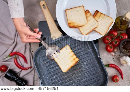 Sliced Bread Fried On Grill Frying Pan At Domestic Kitchen