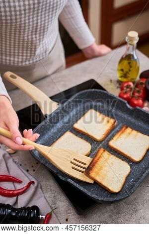 Sliced Bread Fried On Grill Frying Pan At Domestic Kitchen