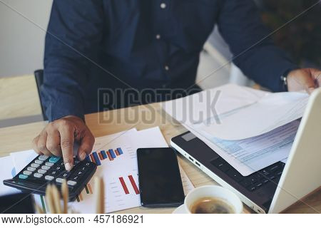 Budget And Tax Planning Concept, Accountant Hand Is Calculating Company Annual Tax And Using Calcula