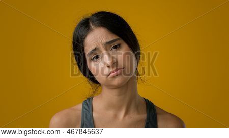 Sad Upset Worried Indian Woman Girl In Yellow Studio Background Dissatisfied Female Face With Bad Bo