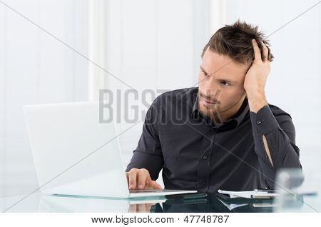 Stressed Man Working On Laptop