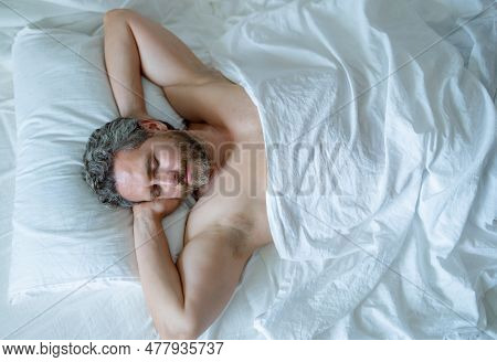 Man Sleeping In Bed. Top View Of Handsome Man Sleeping In Bed. Morning Healthy Sleep. Guy Sleeping O