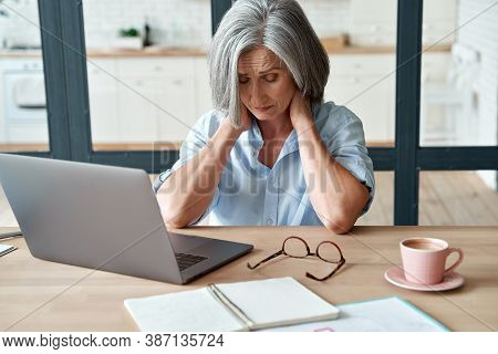 Tired Stressed Old Mature Business Woman Suffering From Neckpain Working From Home Office Sitting At