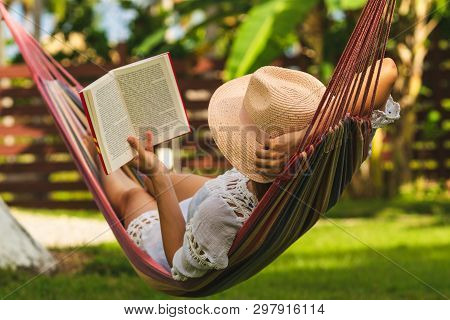 Beautiful Woman Relaxing In Hammock. Beautiful Woman Reading Book In Hammock. Happy Beautiful Woman 