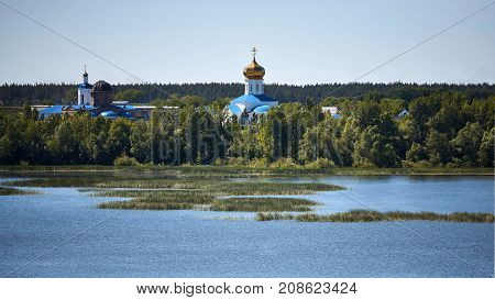 Church on the river bank on a sunny day