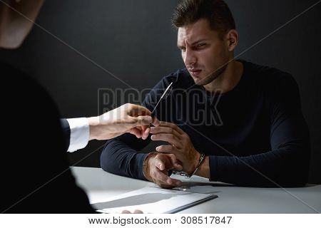 Criminal Man In Interrogation Room Being Interrogated And Refusing To Admit Crime