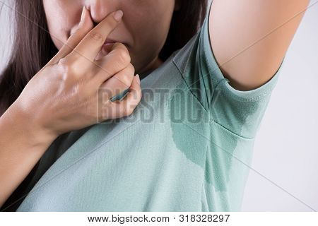 Close-up Asian Woman With Hyperhidrosis Sweating. Young Asia Woman With Sweat Stain On Her Clothes A