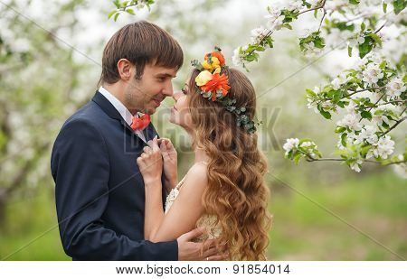 The bride and groom - photo in a flowery Park in the spring.