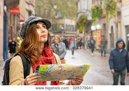 Traveler Woman With Map In Vacation. Woman Traveler In Vacation. Woman Traveling Alone With Map In V