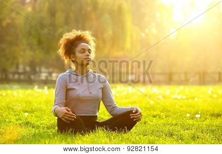 African American Woman Meditating In Nature