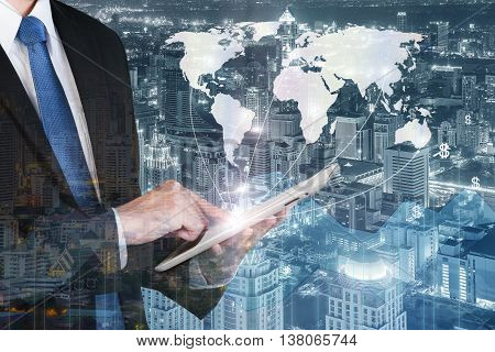 Business technology concept - Business man press digital tablet to show global network business partnership connection with financial business graph. (Elements of this image furnished by NASA)