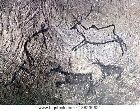 Black Carbon Paint Of Human Hunting On Sandstone Wall,